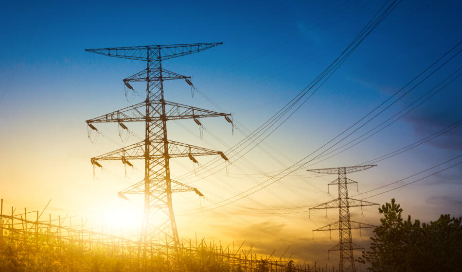 Sun setting silhouette electricity pylons